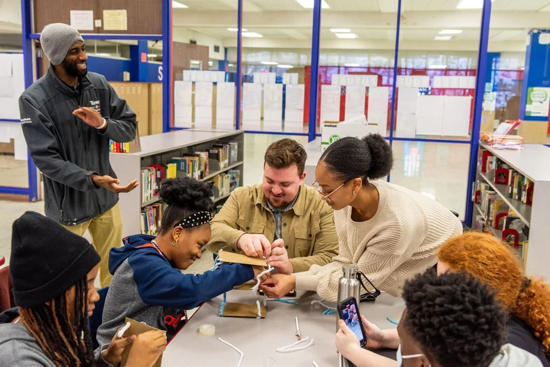 Alaina Battle Volunteers with the ACE program provide a building demonstration for students at Lincoln West High School.