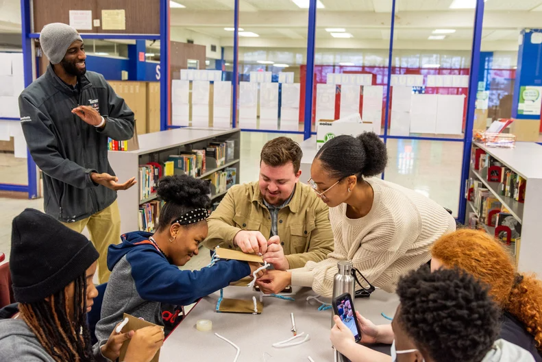 Volunteers with the ACE program provide a building demonstration for students at Lincoln West High School.